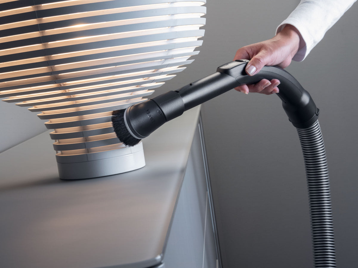 Genuine Miele SSP 10 Dusting Brush with Flexible Swivel Joint — shown dusting window blinds