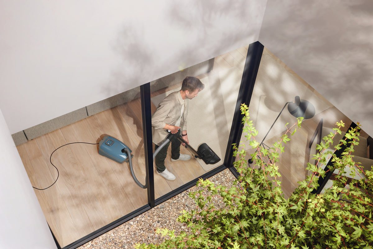 Miele Guard L1 canister vacuum and floorhead on a hard floor