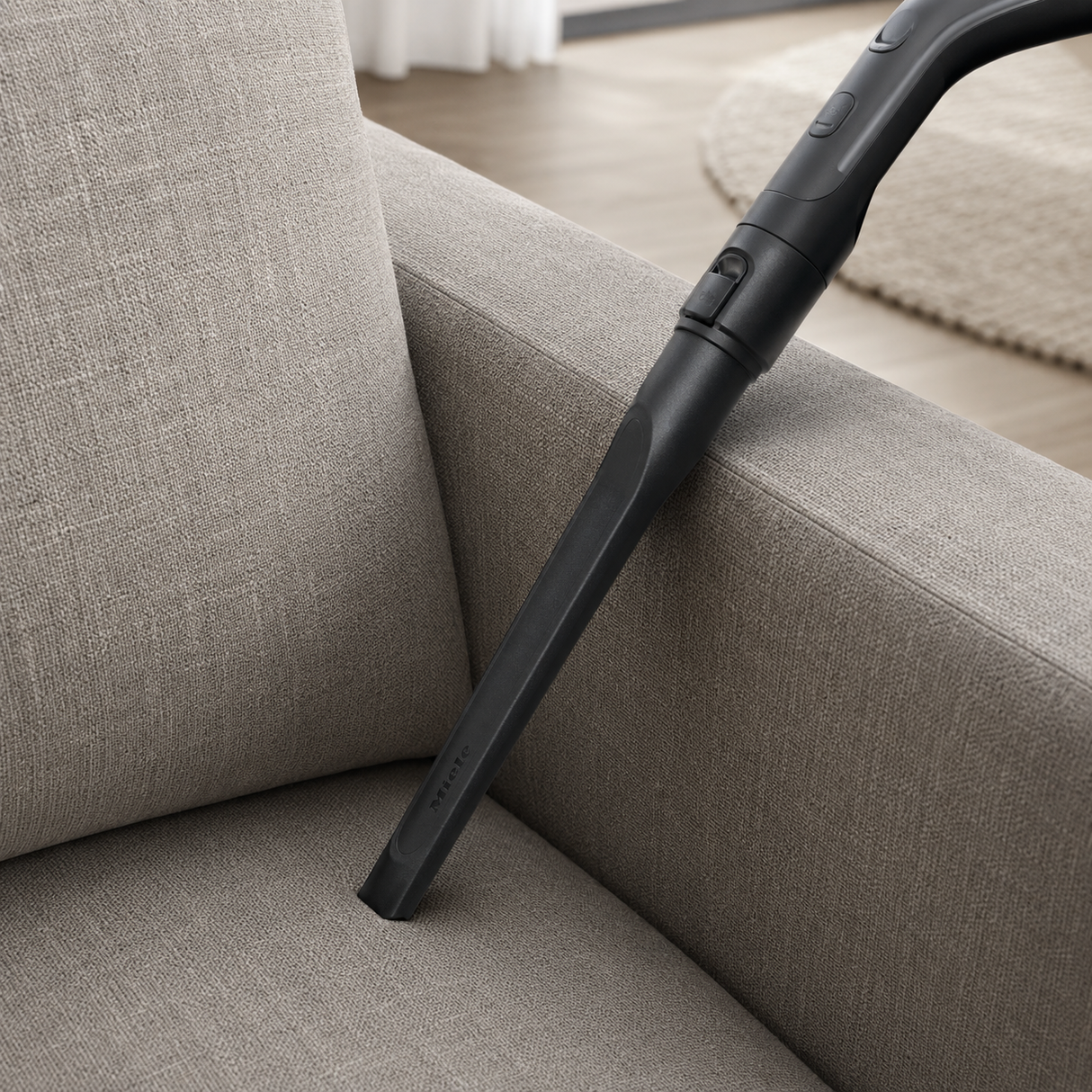 Genuine Miele SFD 10 Long Crevice Nozzle shown in a realistic home or maintenance setting