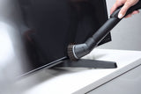 Genuine Miele SSP 10 Dusting Brush with Flexible Swivel Joint — shown dusting a television base
