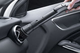 Genuine Miele SSP 10 Dusting Brush with Flexible Swivel Joint — shown cleaning a vehicle dashboard vent