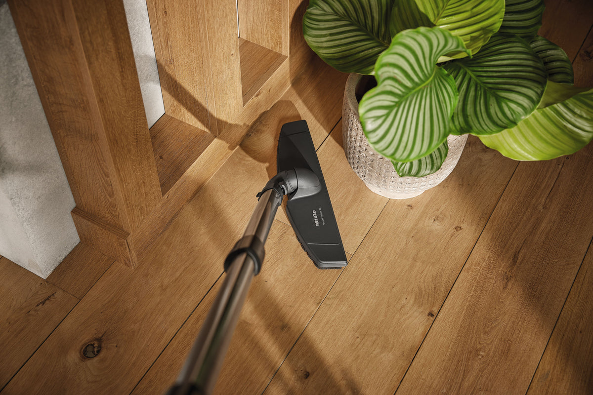 Genuine Miele Parquet Twister XL parquet brush | 7101160 — shown cleaning around furniture