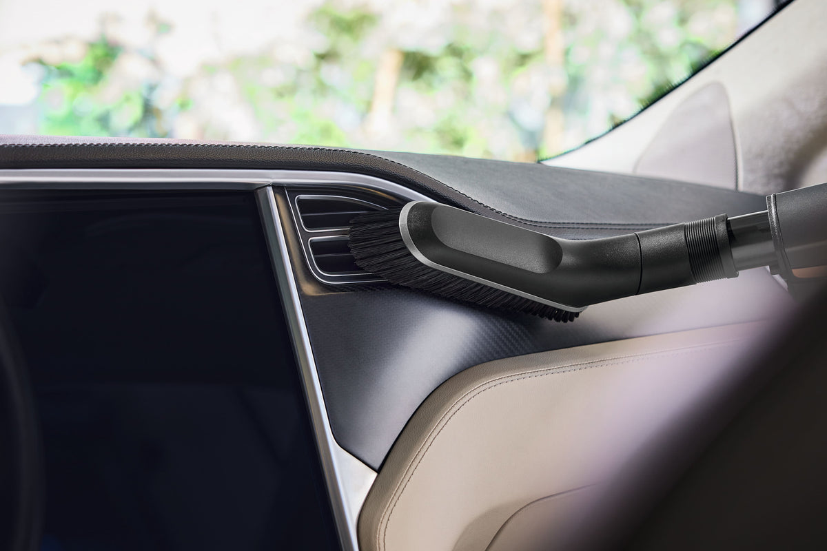 Miele HX-UB Universal Brush for Cordless Sticks — shown cleaning a vehicle door panel