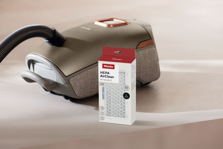 Genuine Miele XL pack HEPA AirClean filter | 12868960 — filter packaging shown beside a compatible vacuum
