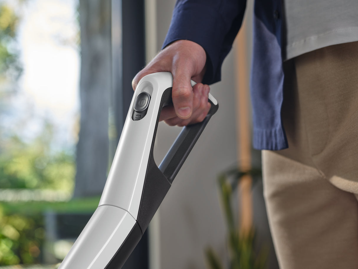 Miele Triflex HX2 Lotus White — handheld upholstery lifestyle