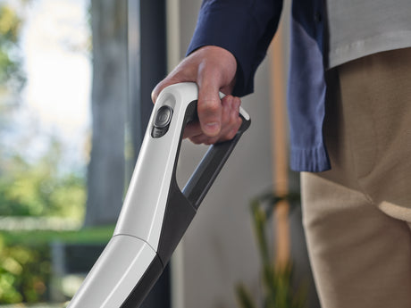 Miele Triflex HX2 Lotus White — handheld upholstery lifestyle