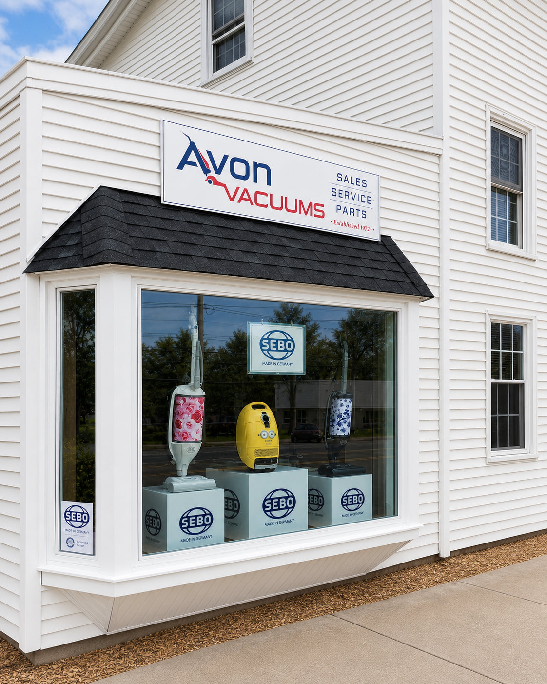 Avon Vacuums storefront on West Main Street, with the Avon sign and SEBO window display