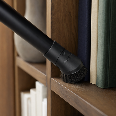 Genuine Miele Guard S1 PP Dusting Brush Replacement shown in a realistic home or maintenance setting