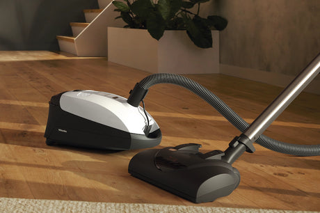 Miele Classic C1 Cat & Dog PowerLine Canister Vacuum on wooden floor – Lotus White