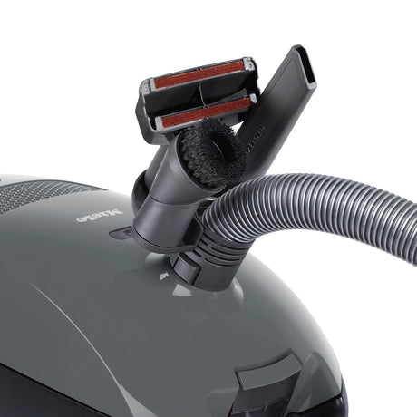 Miele Classic C1 Pure Suction PowerLine accessories – upholstery nozzle, crevice tool, and dust brush attached