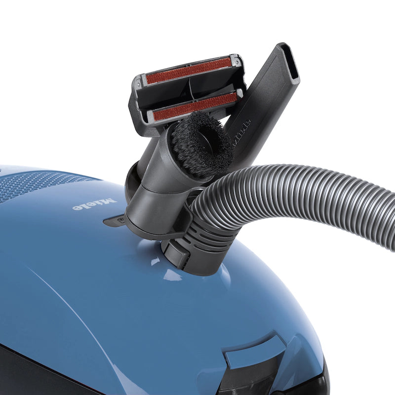 Miele Classic C1 Turbo Team PowerLine accessories – upholstery nozzle, crevice tool, and dust brush attached