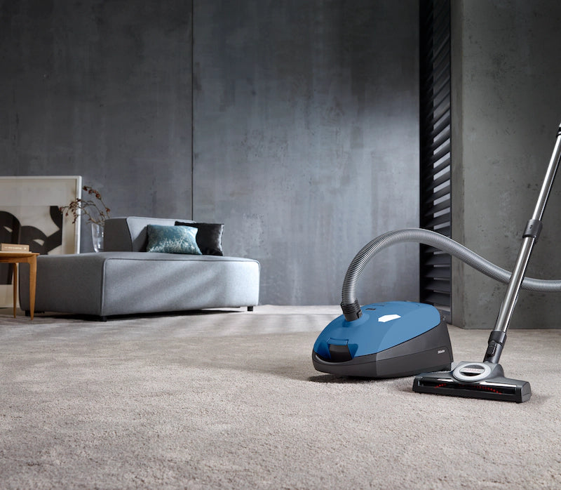 Miele Classic C1 Turbo Team PowerLine Vacuum cleaning carpet in modern living room – Tech Blue