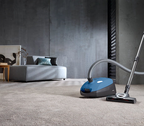 Miele Classic C1 Turbo Team PowerLine Vacuum cleaning carpet in modern living room – Tech Blue
