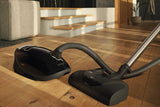 Miele Complete C3 Kona PowerLine Vacuum with Electrobrush on hardwood floor – Obsidian Black
