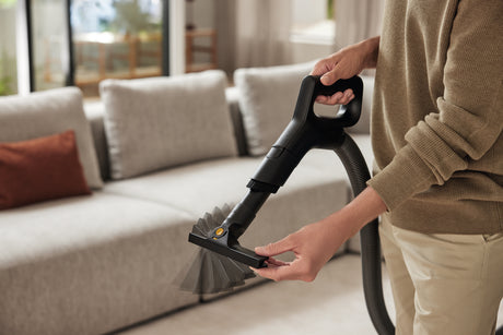 Miele SPFD 20 2-in-1 upholstery and crevice tool extending under furniture in living room